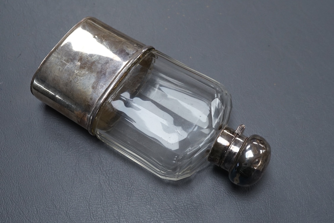 A George V silver mounted glass hip flask, with cup base, by Mappin & Webb, London, 1912, 15.8cm.